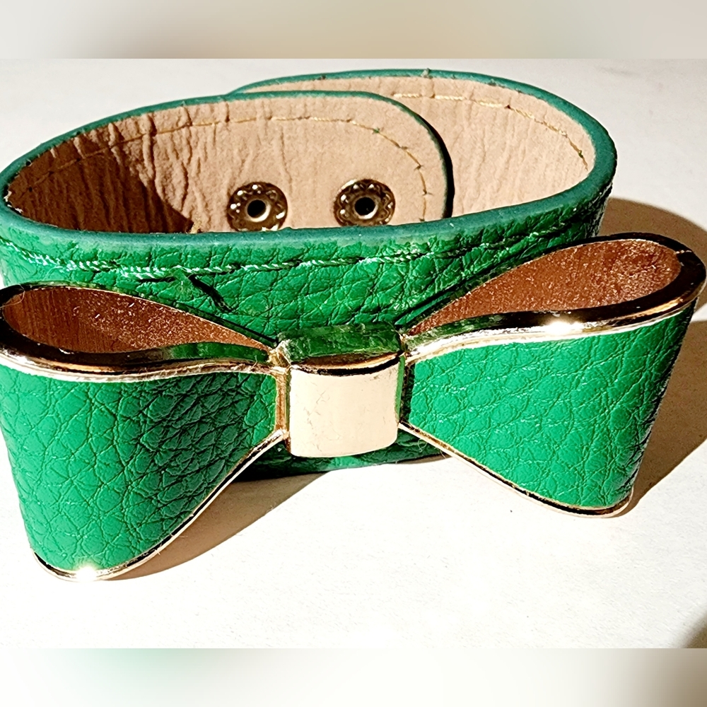 Pebble green snap closure bracelet bow adornment trimmed in gold, luxury,